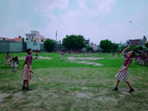 Students playing badminton in school ground